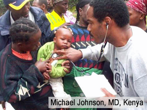 Dr. Michael Johnson examines a baby held by it's mother in Kenya